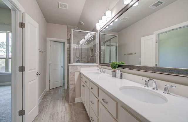 bathroom with vanity and a shower with shower door