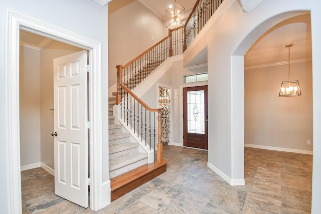 foyer featuring a notable chandelier and crown molding