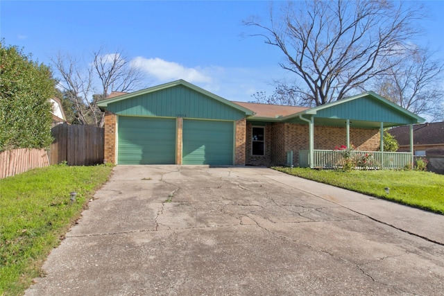 ranch-style house featuring a porch, a garage, and a front lawn