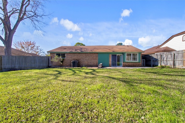 back of property featuring a lawn