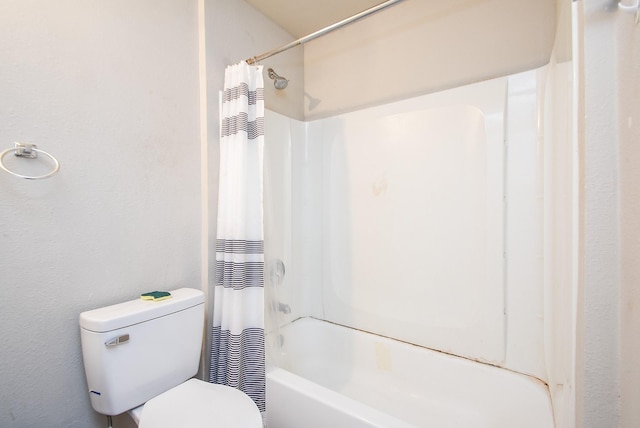 bathroom with toilet and shower / bath combo with shower curtain