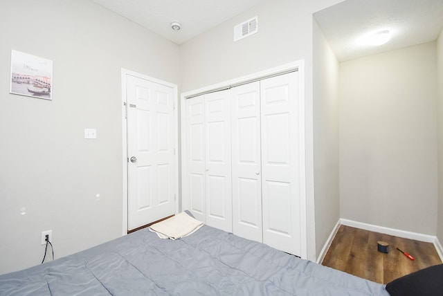 unfurnished bedroom featuring hardwood / wood-style floors and a closet