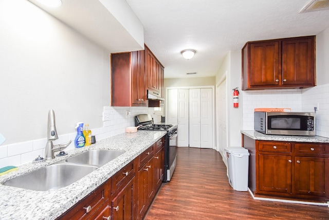 kitchen featuring sink, light stone counters, tasteful backsplash, dark hardwood / wood-style flooring, and stainless steel appliances