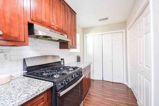 kitchen featuring light stone counters, backsplash, dark wood-type flooring, and range with gas stovetop