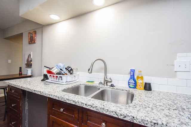 kitchen with light stone countertops and sink