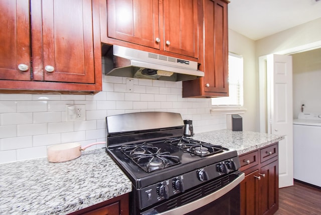 kitchen featuring backsplash, washer / dryer, dark hardwood / wood-style floors, light stone countertops, and black range with gas stovetop