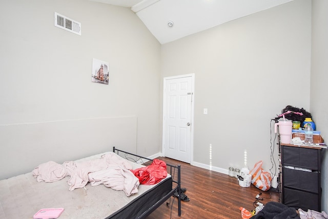 bedroom featuring lofted ceiling and dark hardwood / wood-style flooring