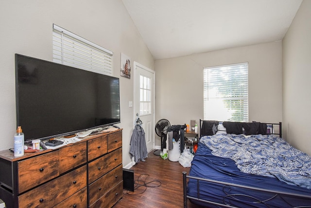 bedroom with vaulted ceiling and dark hardwood / wood-style floors