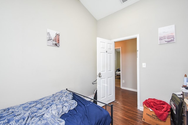 bedroom featuring vaulted ceiling and dark hardwood / wood-style floors