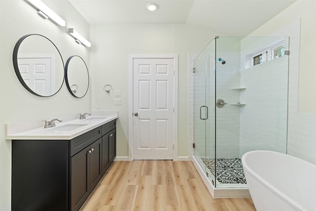 bathroom featuring hardwood / wood-style floors, vanity, and independent shower and bath