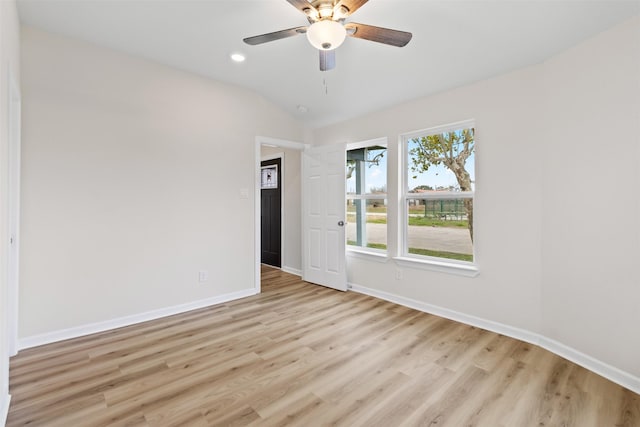 unfurnished room featuring ceiling fan, light wood-type flooring, and vaulted ceiling