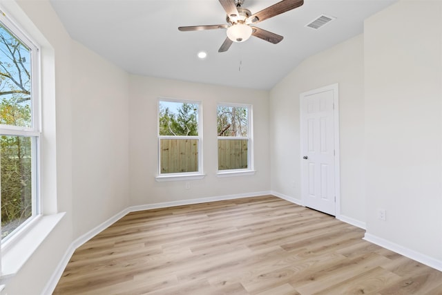 unfurnished room with ceiling fan, vaulted ceiling, and light hardwood / wood-style flooring