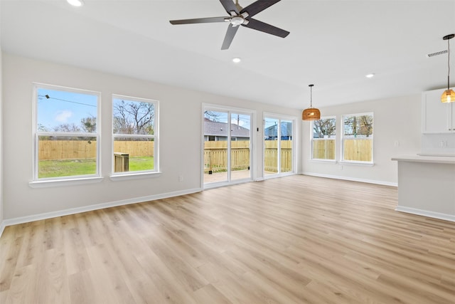 unfurnished living room with ceiling fan and light hardwood / wood-style floors