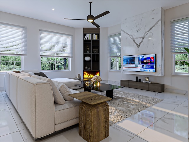 living room with a wealth of natural light and ceiling fan