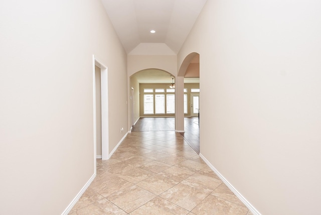 corridor featuring lofted ceiling