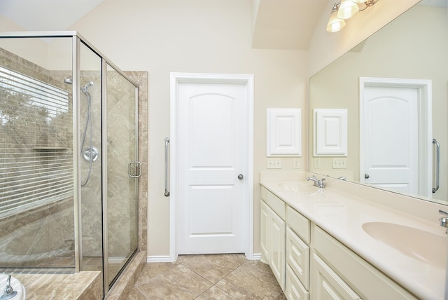 bathroom featuring tile patterned floors, vanity, and a shower with shower door