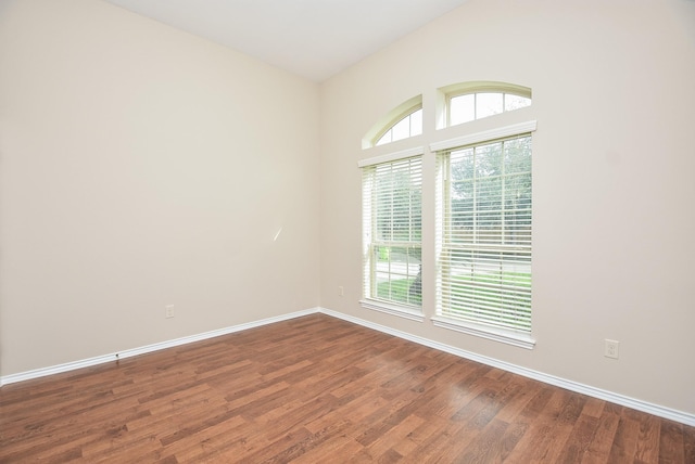 unfurnished room featuring dark hardwood / wood-style flooring