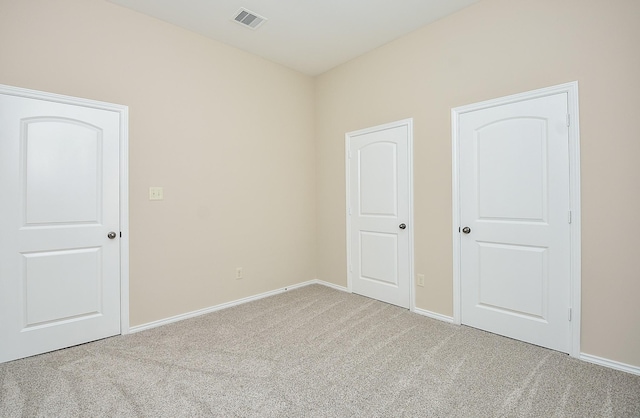 unfurnished bedroom featuring light carpet