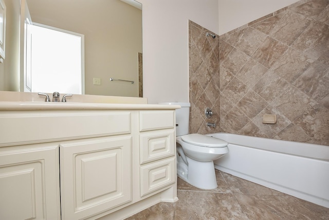 full bathroom featuring toilet, vanity, and tiled shower / bath