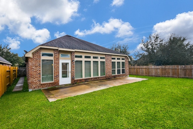 rear view of property featuring a patio area and a yard