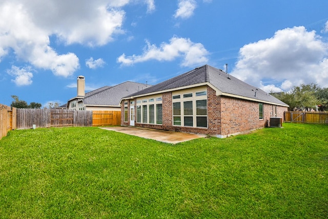 back of house with a lawn, a patio, and central AC