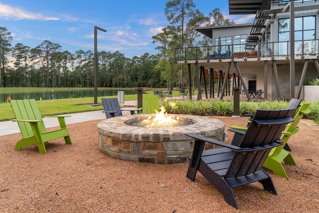 view of patio / terrace with a water view and an outdoor fire pit