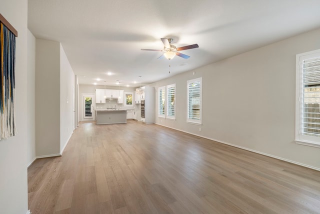 unfurnished living room featuring light hardwood / wood-style floors and ceiling fan