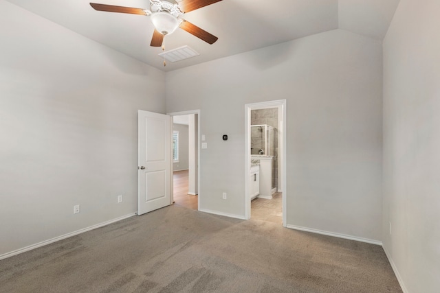 unfurnished bedroom featuring ensuite bathroom, ceiling fan, light carpet, and high vaulted ceiling