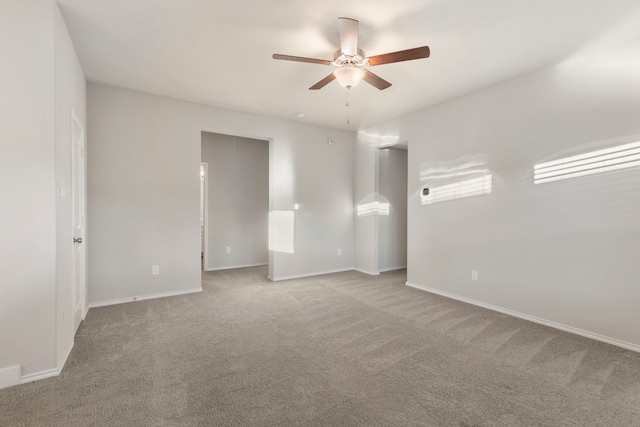 empty room with light colored carpet and ceiling fan