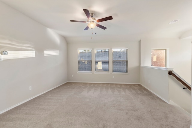 carpeted empty room featuring ceiling fan