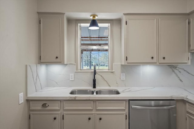 kitchen with dishwasher, sink, decorative backsplash, light stone countertops, and white cabinetry