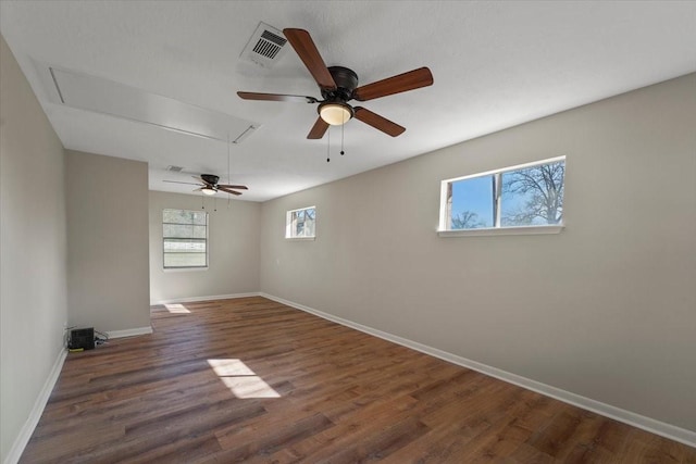 unfurnished room with ceiling fan and dark wood-type flooring