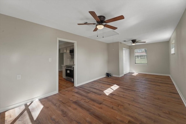 empty room with ceiling fan and dark wood-type flooring