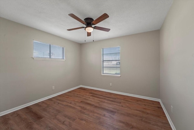 unfurnished room featuring a textured ceiling, ceiling fan, and dark wood-type flooring