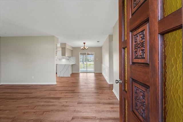 interior space featuring a chandelier and light hardwood / wood-style floors