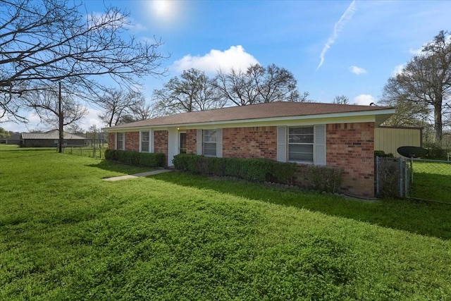 ranch-style home featuring a front yard