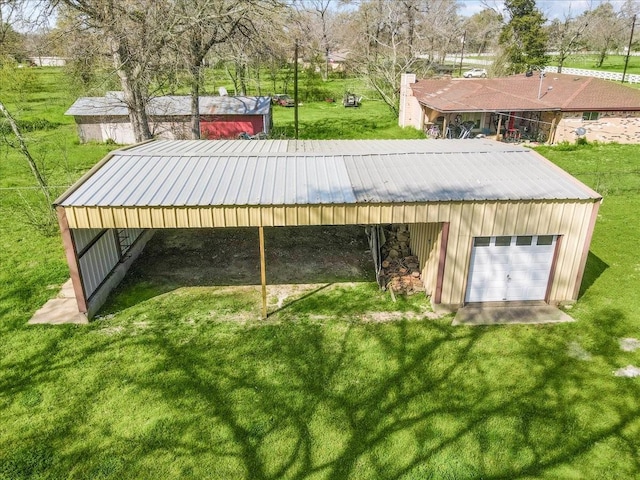 view of property's community featuring a yard and an outdoor structure