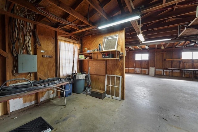 interior space featuring electric panel and concrete flooring