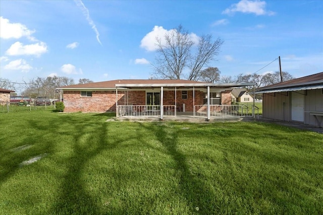 back of property featuring a lawn and a patio area