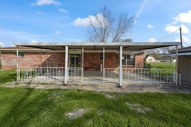 rear view of house with a lawn