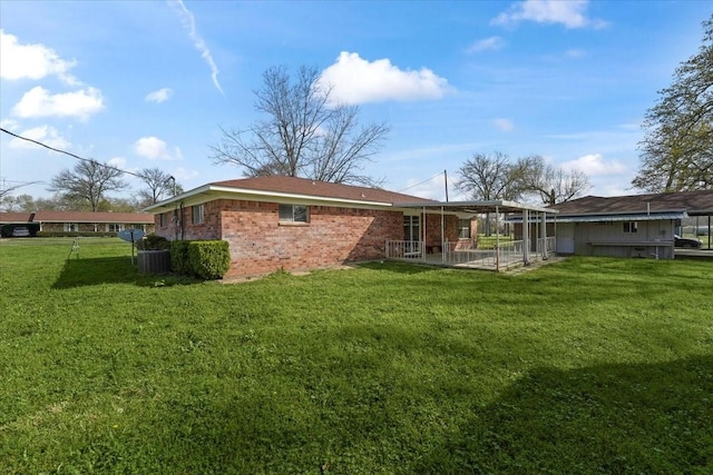 back of property featuring a lawn and a patio area