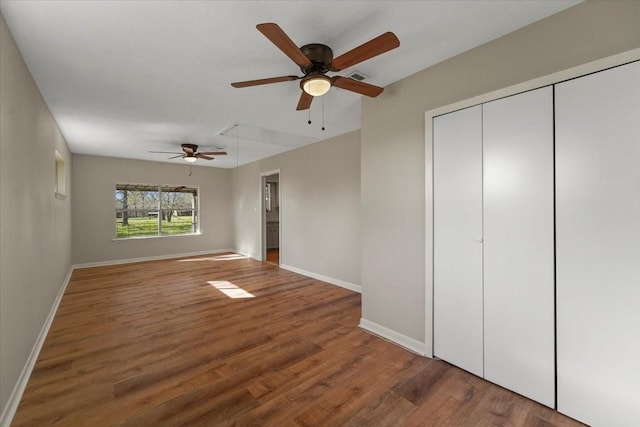 unfurnished bedroom with dark hardwood / wood-style flooring and ceiling fan