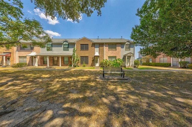 view of property featuring a front lawn