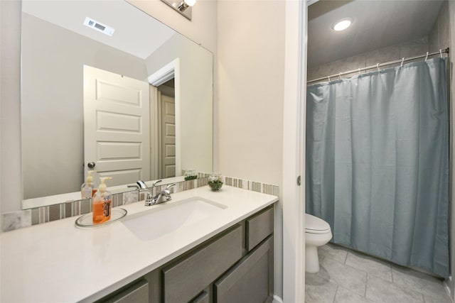 bathroom with tile patterned floors, vanity, and toilet