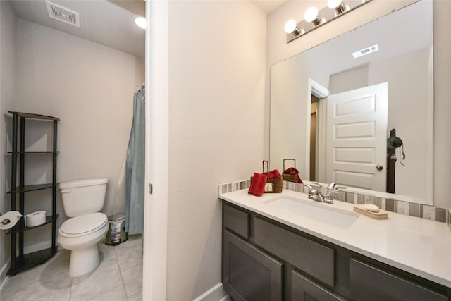 bathroom featuring vanity, tile patterned floors, and toilet