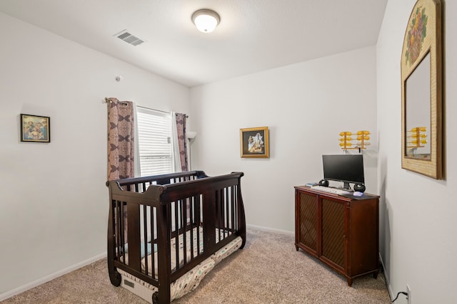 carpeted bedroom with a nursery area