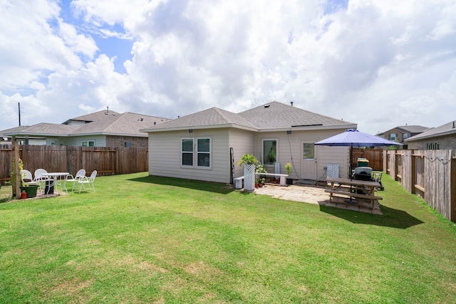 back of property featuring a yard and a patio