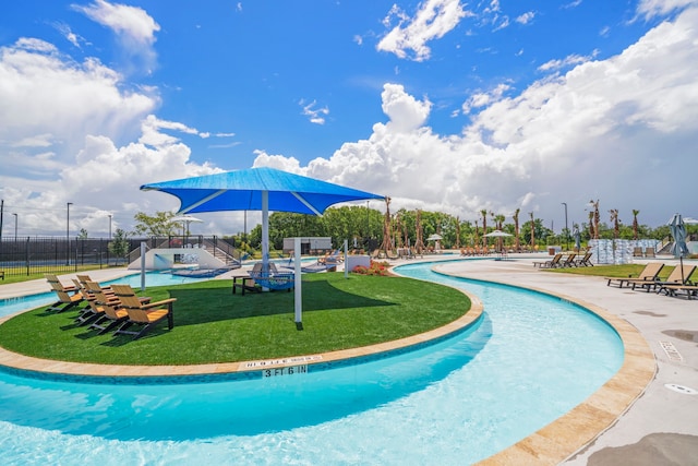 view of swimming pool with a patio area and a yard