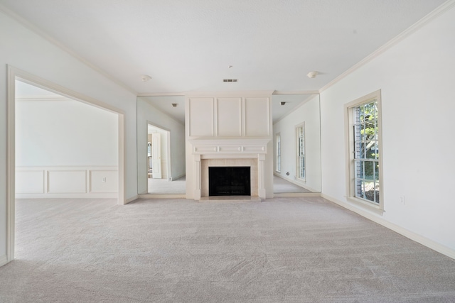 unfurnished living room with light colored carpet and crown molding