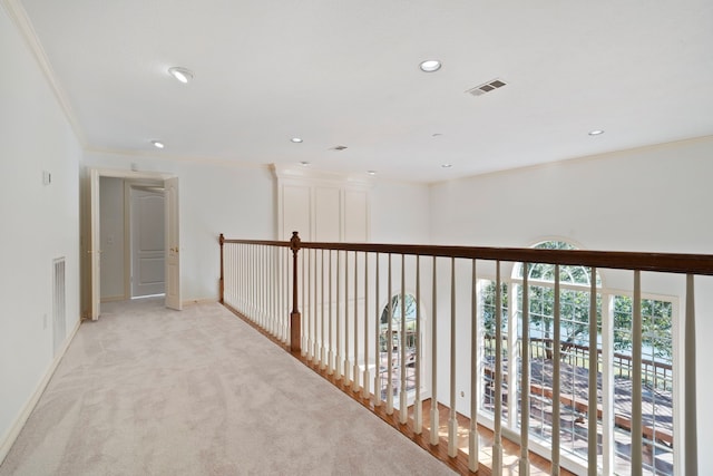 hallway featuring light colored carpet and crown molding